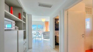 A modern interior with a kitchen, dining area, and a view to the outside. - Attico al Parco: Penthouse in Lugano Balcony, A/C & 2 min From Lake (Lugano)