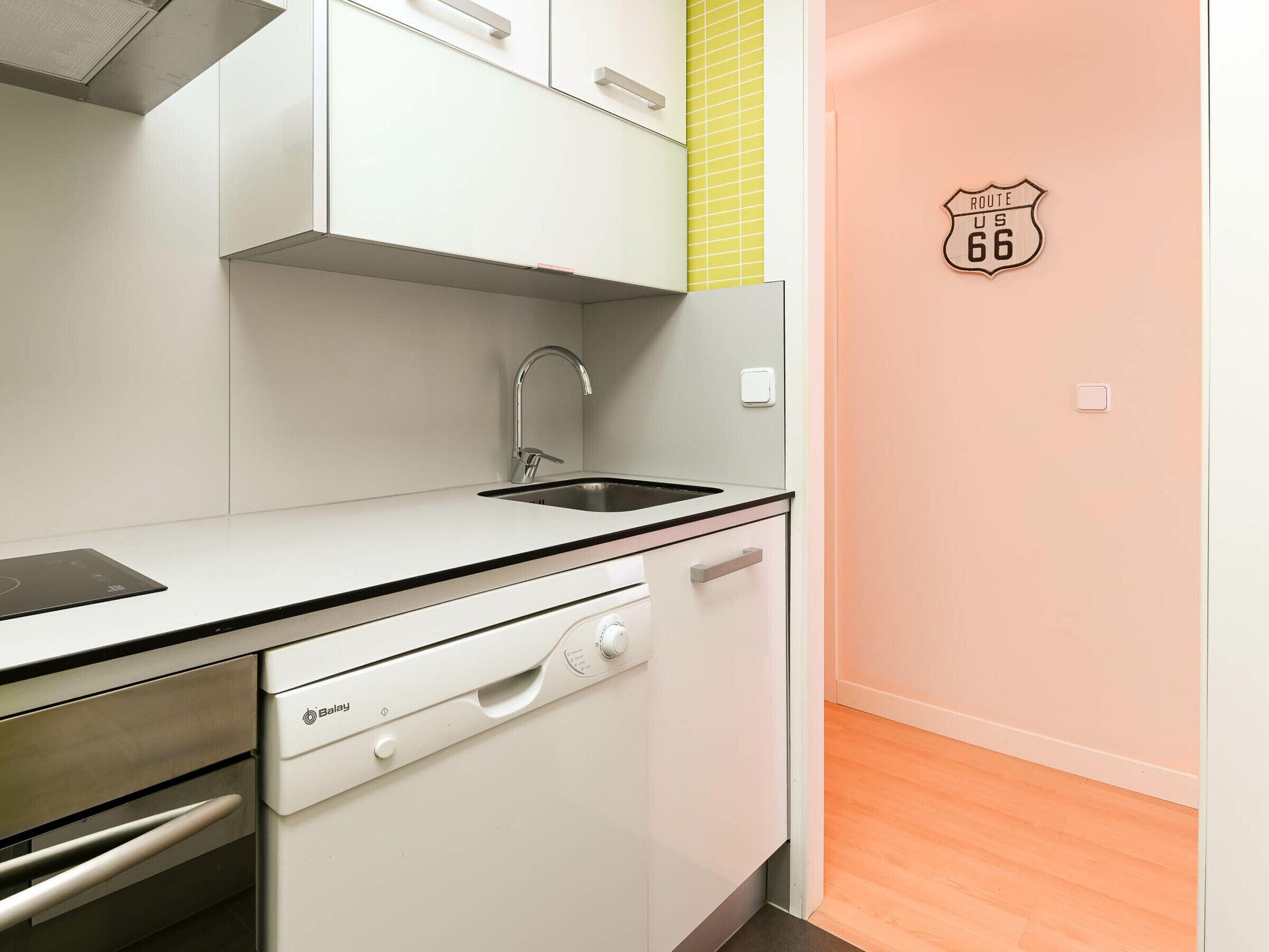 A compact kitchen with a dishwasher, a sink, and a stove.