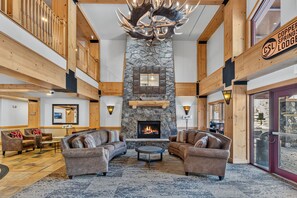 A spacious lobby with a stone fireplace, leather sofas, and a chandelier. - 1 Minute Walk to the Super Bee Chair! Enjoy the Best of Copper from this Beautif (Frisco)