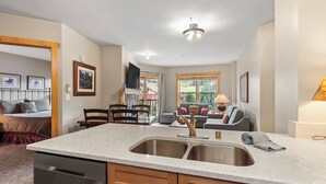 A modern kitchen with a central island, double sink, and wooden cabinetry. - 1 Minute Walk to the Super Bee Chair! Enjoy the Best of Copper from this Beautif (Frisco)