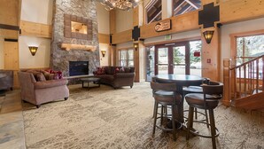 A spacious lobby with a stone fireplace, a high ceiling, and a view of the outdoors. - 1 Minute Walk to the Super Bee Chair! Enjoy the Best of Copper from this Beautif (Frisco)