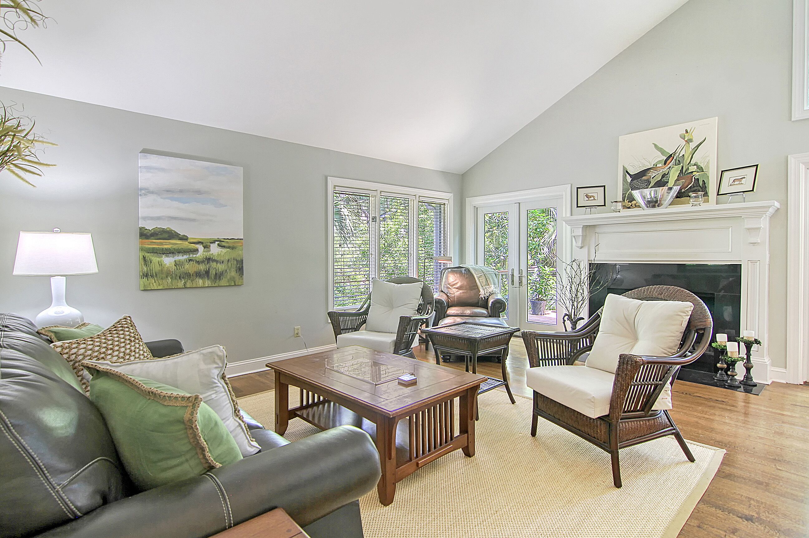 A living room with a fireplace, a sofa, a coffee table, and a chair.