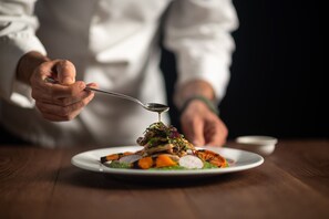 A person serving food from a plate.