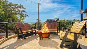 A patio with wooden chairs and a fire pit. - Million $ Views, Game RM, Pvt Pool, Lux (Sevierville)