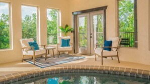 A pool area with chairs and a view of greenery outside. - Million $ Views, Game RM, Pvt Pool, Lux (Sevierville)