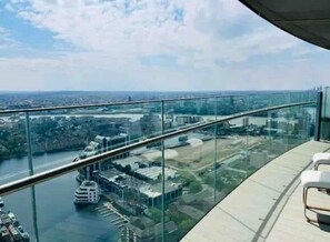 Enjoy breathtaking views of the city from this high-rise's expansive balcony.