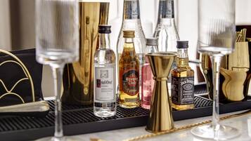 A bar area with various bottles of alcohol, including vodka, whiskey, and other spirits, arranged on a tray.