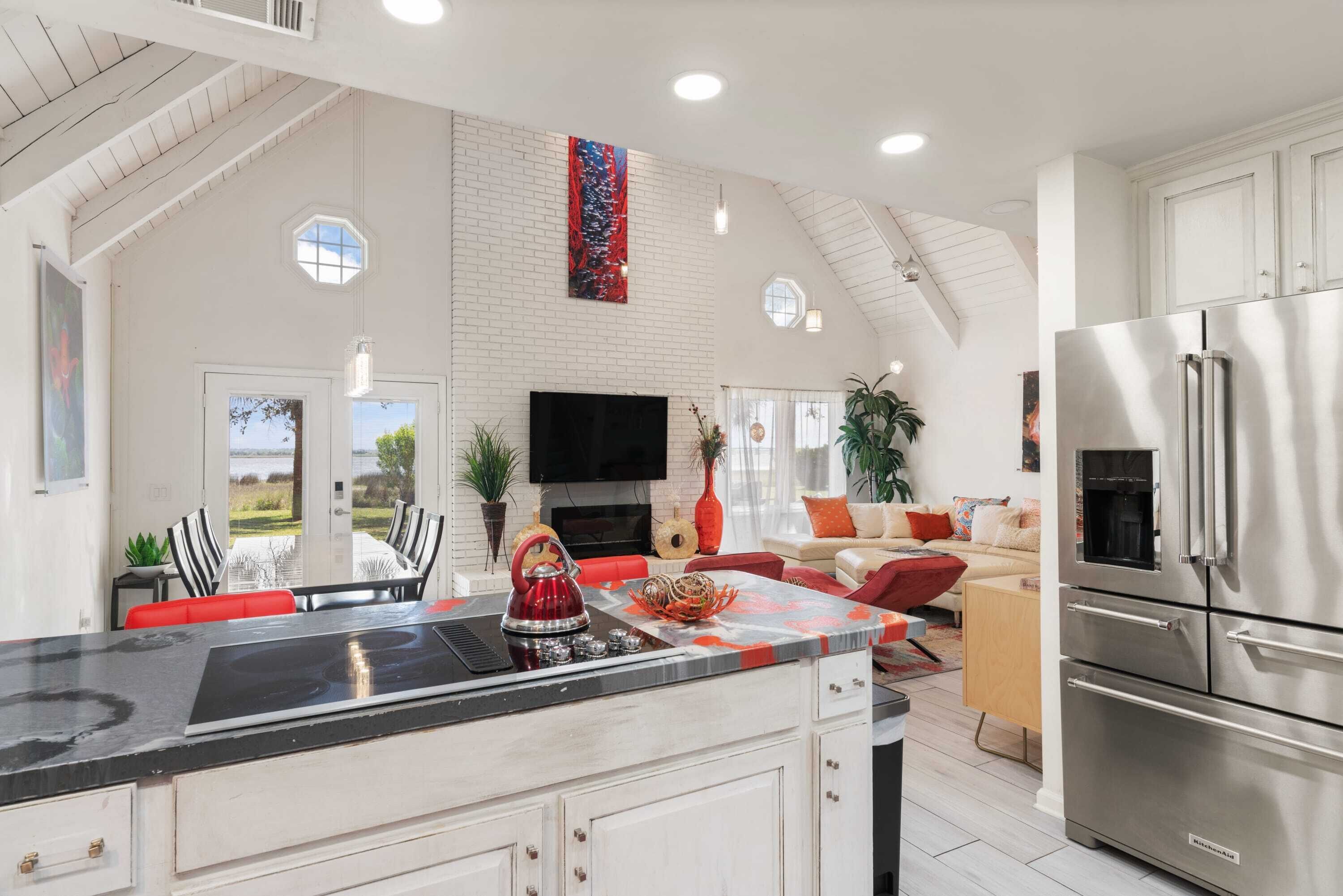 A spacious kitchen with a large island, built-in appliances, and a dining area with outdoor views.