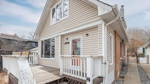 A two-story house with a front porch, a chimney, and a garage.