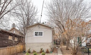 Cozy single-story home with a gabled roof and attached garage, set amidst a suburban neighborhood.