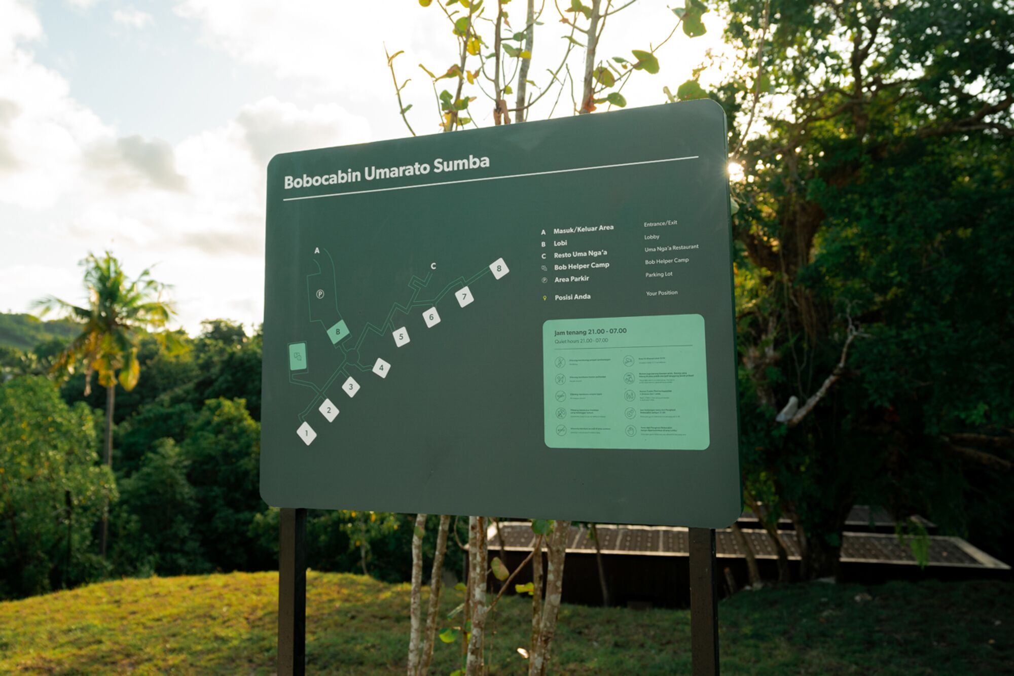 A directional sign for Bobocabin Umarato Sumba with labeled sections A to C, including a lobby, restaurant, and camp.