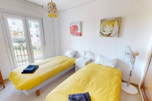 A room with two beds, a ceiling fan, and artwork on the walls. - Beautiful apartment overlooking the pool- MO2411LT (La Torre Golf Resort)