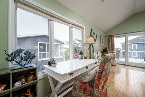 Enjoy a peaceful retreat with a large window offering views of the surrounding neighborhood, a comfortable couch, and a convenient desk with storage.