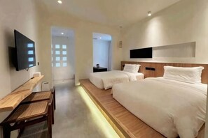 A hotel room with two beds, a desk, a TV, and a view of the outside. - WuzhenThose Years, Those Events, Those People (Tongxiang)
