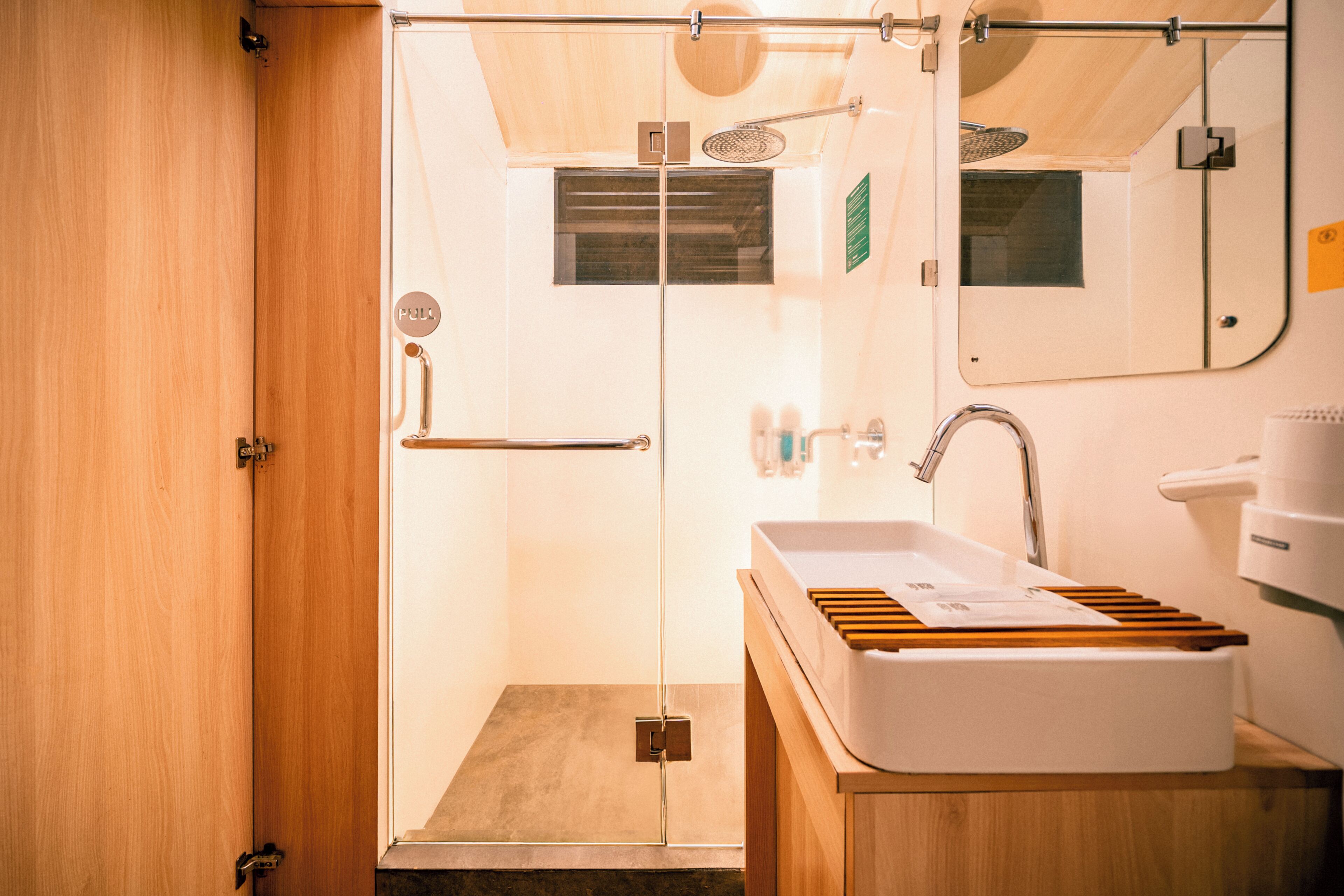 A bathroom with a shower, sink, and mirror.