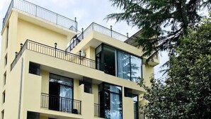 A multi-story building with balconies and large windows. - Hotel Gurya (Kobuleti)