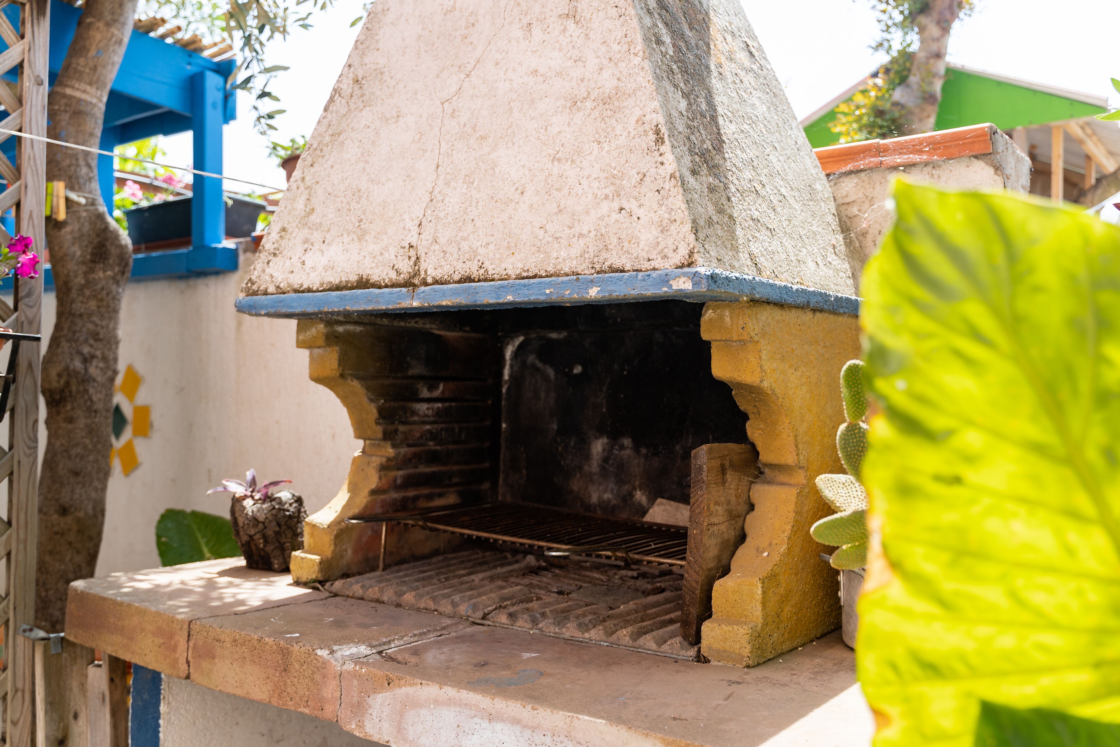 Forno de pedra tradicional com telhado cónico, possivelmente usado para cozinhar ou assar.