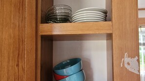 A wooden cabinet with shelves holding stacked plates and bowls. - Quiet Get away Lot #2 fisherman, family, Pet friendly, boat ramp, dock, Beaches (Port Clinton)