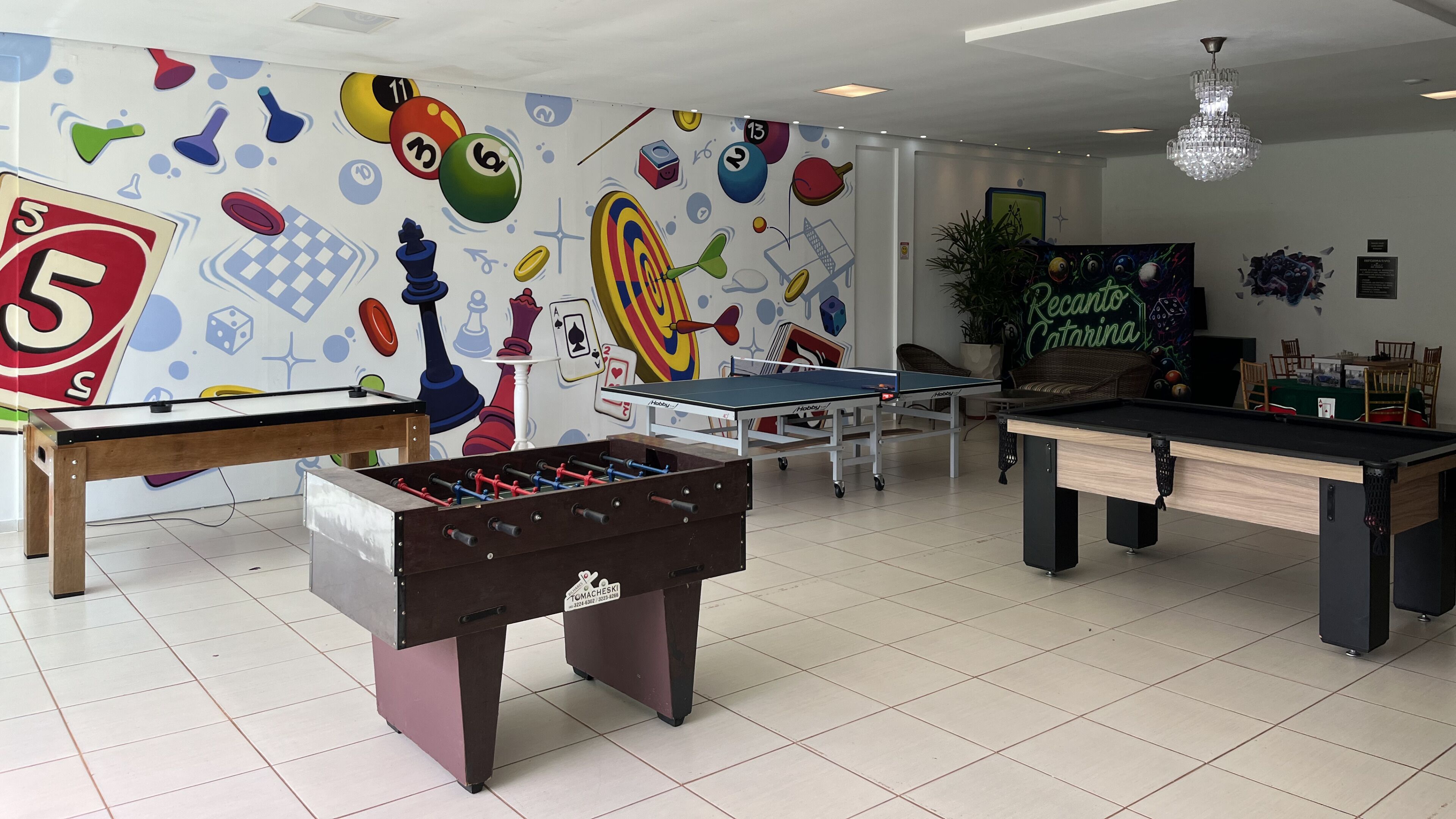 Una sala ricreativa con tavoli per il calcio balilla, ping pong e biliardo.