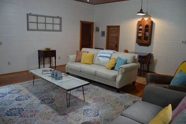 A living room with a sofa, a coffee table, and a cabinet.
