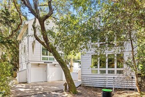 A white two-story building with a garage labeled "SANDY CHEEKS."