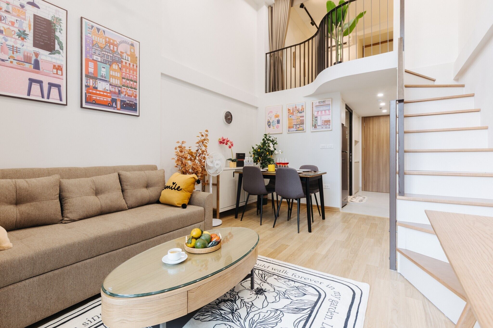 A modern living room with a sofa, coffee table, and dining area.