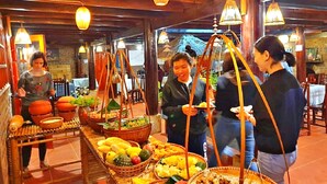 A buffet setup with various food items and a traditional wooden interior. - Resort Pù luông Boutique Garden (Pu Luong)