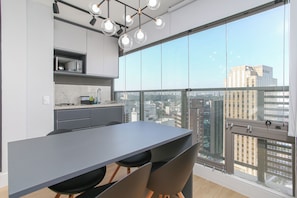 Exclusive Studio Suite | Living area | Flat-screen TV