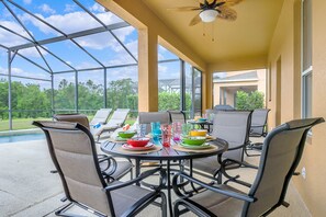 Outdoor dining - South Facing 6 Bed 5 Bath Themed Pool & Spa Home @ Emerald Island Resort (Kissimmee)