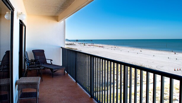 A balcony with wicker chairs and a view of a beach. - Surfside 503 - 2 Bedroom 2 Bath Oceanfront Condo (Clearwater)