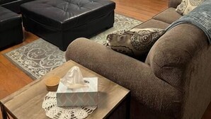 A living room with a black leather sofa, a brown couch, and a wooden coffee table. - X Marks the Spot (Purple) (Santa Claus)