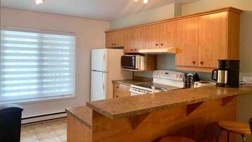 Fridge, coffee/tea maker, toaster, cookware/dishes/utensils