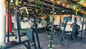 A gym with various exercise equipment, including weight machines and benches. - 247 Luxury Apartment (Lekki)
