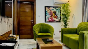 Luxury Apartment | Living area | 43-inch Smart TV with satellite channels, TV