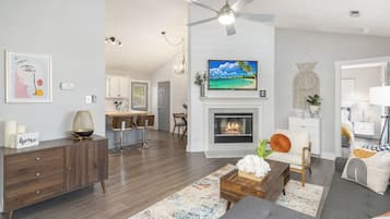 Smart TV, fireplace, books, computer monitors