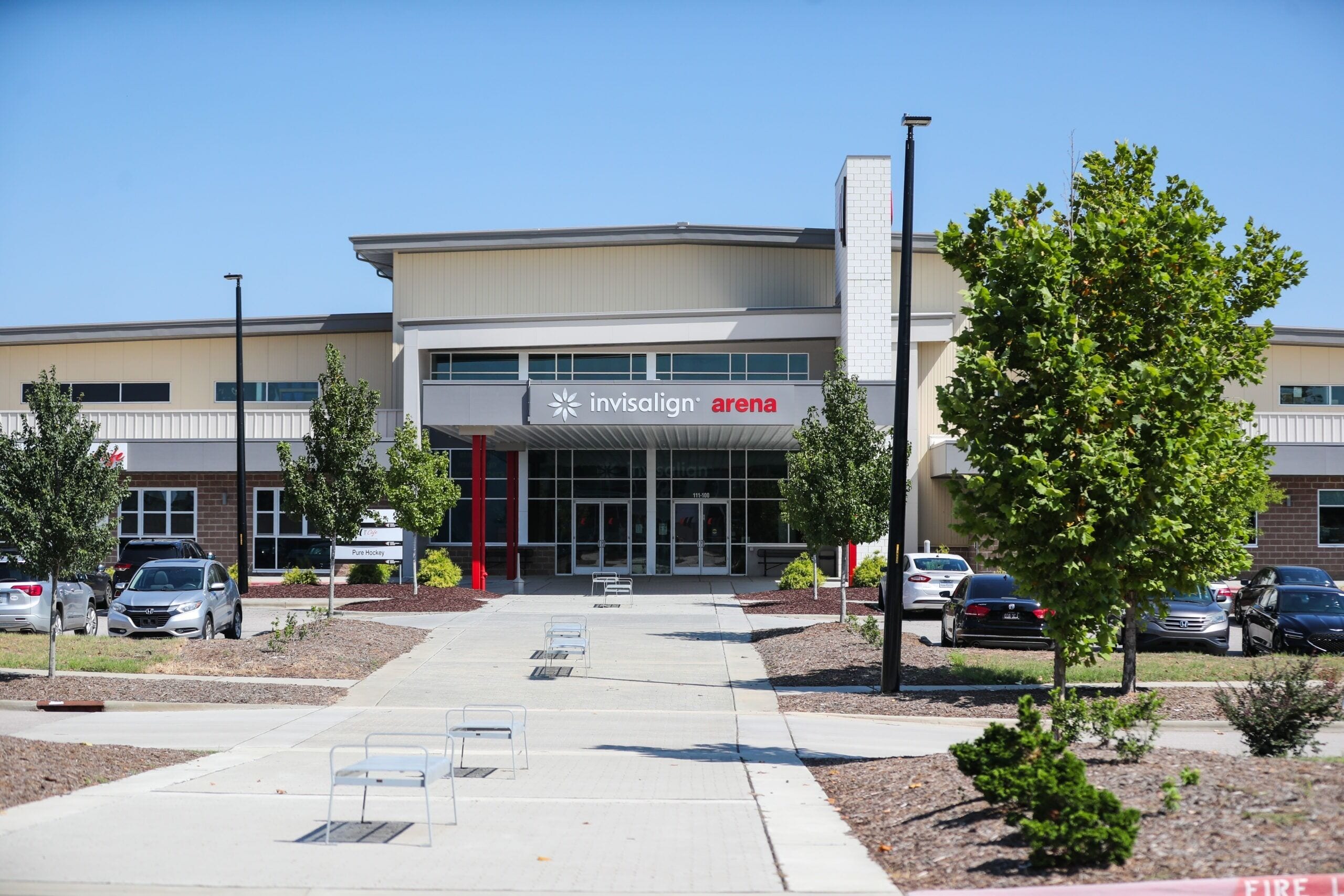 A modern building with a sign reading "Invisalign Arena".