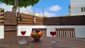 A wooden table with a fruit bowl and two wine glasses. - STAY Napa Velvet (Ayia Napa)