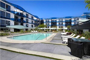 Relax by the pool surrounded by lush gardens and lounge chairs.