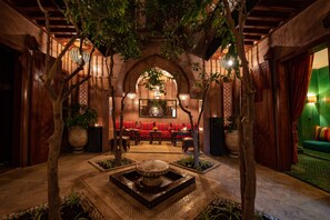 An indoor courtyard with a fountain, seating area, and potted plants. - Riad Livia Marrakech - Adults Only  (Marrakech)