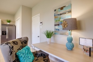 Relax in a stylish living area with a sofa, coffee table, and potted plant.