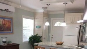 A kitchen with a dining area, a refrigerator, and a ceiling fan. - Your Happy Place (Melbourne)