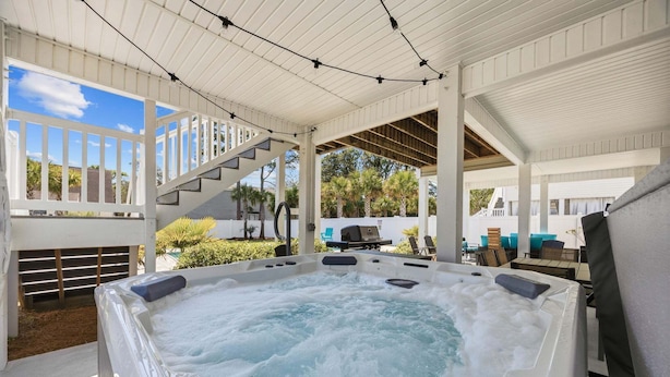 A hot tub in a covered outdoor area with a view of the surrounding landscape. - Landing Zone | Pet-Friendly 4BR w/ Pool + Hot Tub (North Myrtle Beach)