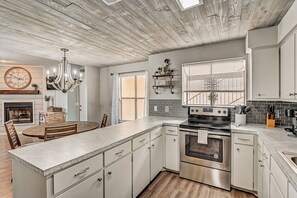 Fridge, microwave, oven, stovetop - Dog-friendly water view condo with inviting porch, AC, W/D, & modern charm (Horseshoe Bay)