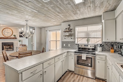 Dog-friendly water view condo with inviting porch, AC, W/D, & modern charm