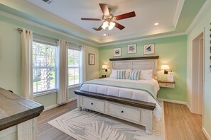 A bedroom with a bed, a ceiling fan, a nightstand, and a window with curtains. - Resort Home ~ 1 Mi to Myrtle Beach Access! (Myrtle Beach)