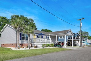 A two-story house with a covered porch, a small garden, and a golf cart parked in front. - Resort Home ~ 1 Mi to Myrtle Beach Access! (Myrtle Beach)