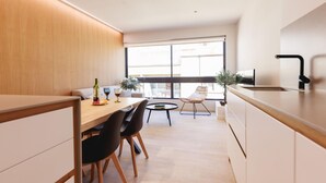 A modern kitchen with a dining area, large windows, and a view of the outside. - Bravissimo Centre, Modern 2-bedroom apartment (Girona)