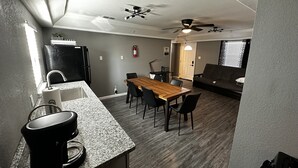 A compact living space with a kitchenette, dining area, and a sofa. - 2-Bedroom in the Heart of SA (San Antonio)