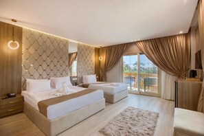 A modern hotel room with a large bed, two smaller beds, a sofa, a TV, and a balcony with curtains.
