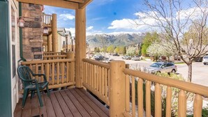 A wooden deck with a view of a parking lot and mountains. - Adventure Awaits at Mountain Hollow Retreat in Eden! (Eden)